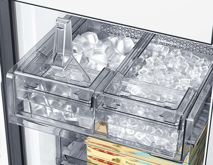 Samsung refrigerator door open showing the ice maker with ice cubes in both compartments