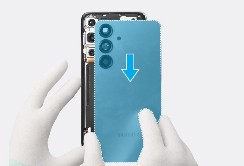 A gloved hand attaching the back cover onto the metal frame of a Galaxy S25 Plus, with a blue highlight indicating the back cover and a blue down arrow icon indicating the attachment direction.