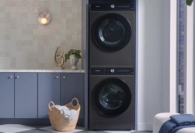 A Samsung washer and dryer stacked and tucked neatly in a laundry room corner with modern appliances