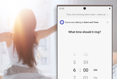Woman waking up next to phone with Bixby alarm