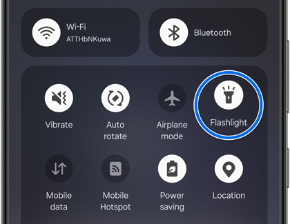 The Quick Settings panel opened with Flashlight highlighted