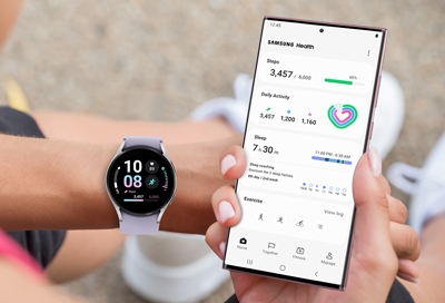 Woman is checking Samsung Health app with Galaxy Watch and Galaxy S22 Ultra
