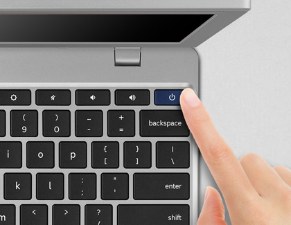 Finger hovering over the Power button on a Chromebook