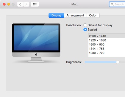 Mac display settings showing resolution options and a brightness adjustment slider.