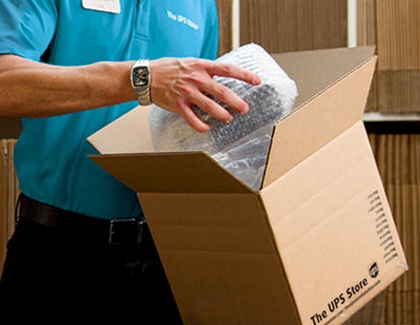 A man packing a product in the UPS Store