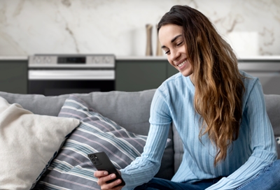 Woman using Smart Control from couch
