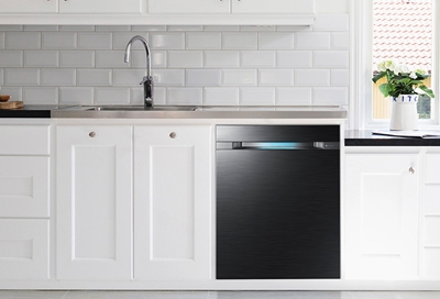 A black dishwasher underneath a white countertop