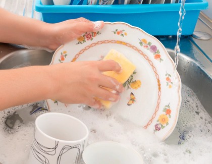 Girl washing china with water