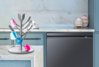 Baby bottles on a Wash stand with Samsung Dishwasher in the background