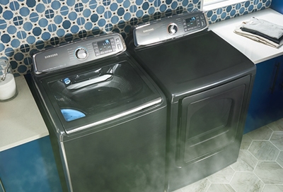 A dryer emitting smoke into a laundry room