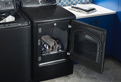 An open Samsung dryer with clothes inside