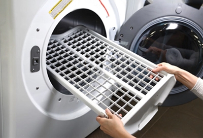 Person inserting a dryer rack into the Samsung dryer