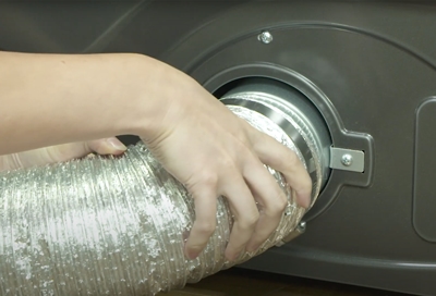 A person checking  the Samsung dryer duct