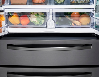 Crisper drawers inside a Samsung fridge, containing fruits and vegetables