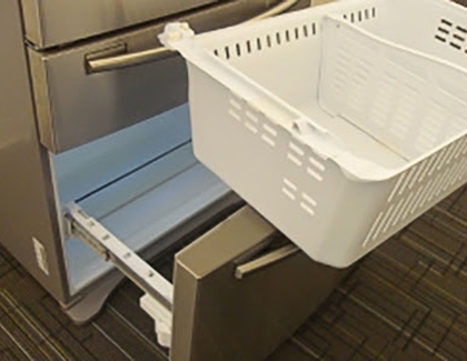 Freezer storage bin being removed