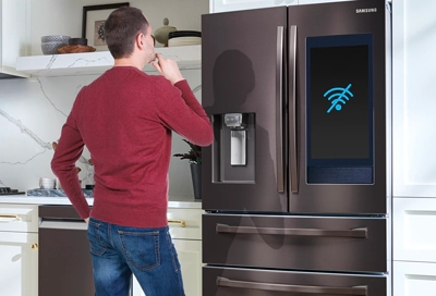Man looking at Family Hub fridge that won't connect to the internet