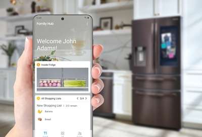 Person holding a phone while setting up the Family Hub app