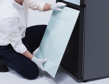 Person lining up the panels on the bottom freezer
