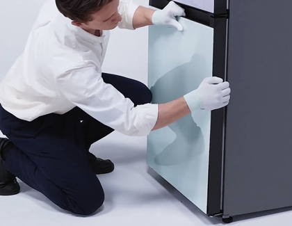 Person locking in the panels on the bottom freezer by pushing the panels
