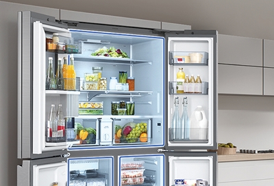 Opened Samsung fridge filled with neatly organized food
