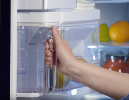 Person removing the pitcher from the fridge