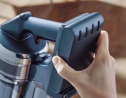 Battery being inserted into the vacuum's handle