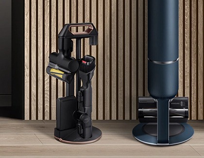 A Samsung Bespoke Jet cordless vacuum next to its charging station with organized attachments