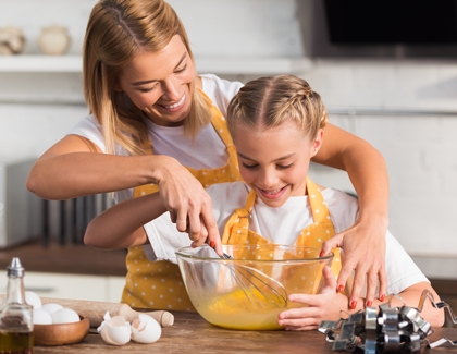 Mother and daughter cooking cookies