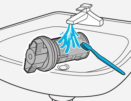 Illustration showing a pump filter being cleaned with water and a toothbrush under a sink faucet