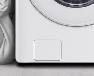 Close-up of the cover concealing the pump filter of a Samsung washer