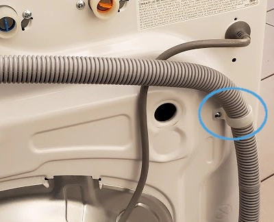 Back view of a Samsung washer, emphasizing the highlighted clamp securing the drain hose