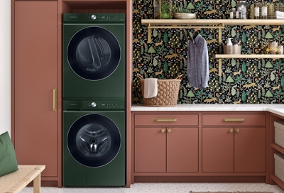 A Samsung washer and a Samsung dryer stacked onto each other in a laundry room