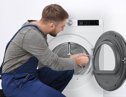 A professional is finishing the installation of a Samsung washer