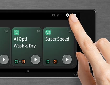 A person pressing the Settings icon on the touch-sensitive control panel of a Samsung Bespoke AI Laundry Combo unit to customize washing options