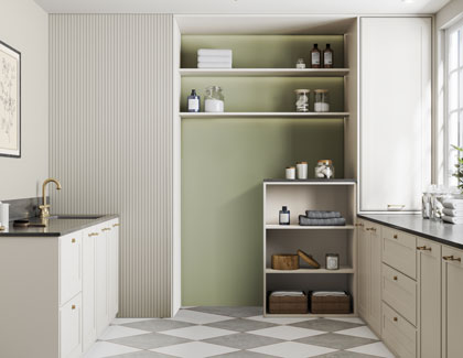 A modern laundry room with beige cabinets, built-in shelves, and a geometric patterned floor.