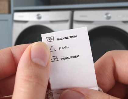 Checking care tag for bleach