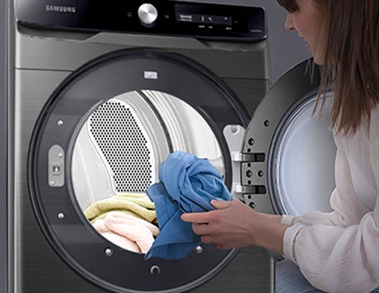 Lady putting clothes in a Samsung washer