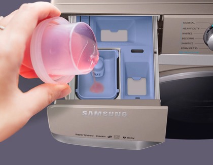 Detergent being put on the detergent drawer in a Samsung washer