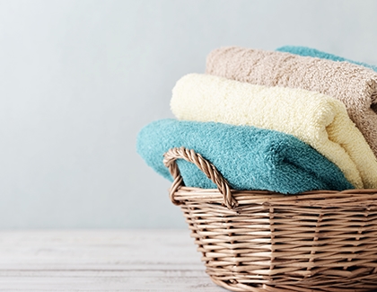 A stack of towels in a laundry basket