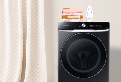 Samsung Washer with assorted curtains and an iron on top