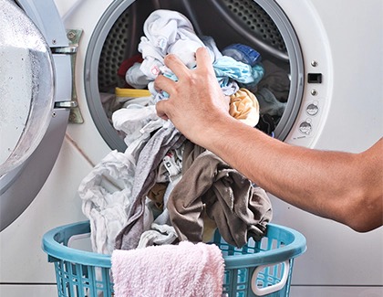 Clothes being taken out of washer
