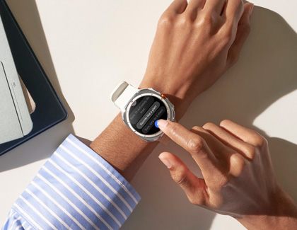 A hand interacting with a Samsung Galaxy Watch Ultra