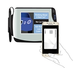 A Galaxy phone positioned in front of a payment terminal with a display for MST payment.