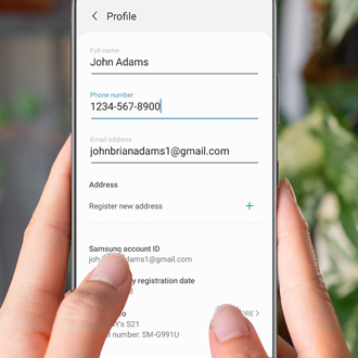 Hand holding a Galaxy phone while editing profile information