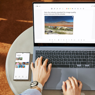 Person using a Galaxy Book with a Galaxy S24 Ultra placed next to them