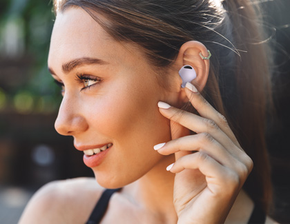 A woman smiling while wearing Galaxy Buds2 Pro