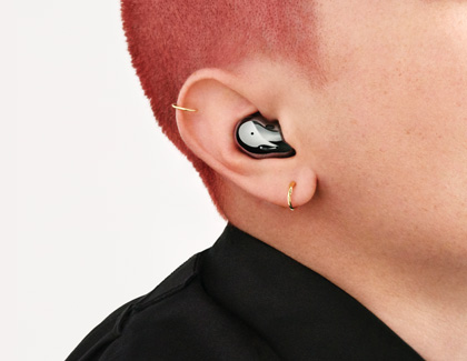 Close-up of a person wearing Galaxy Buds Live