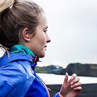 A Women running while wearing Samsung Galaxy Gear IconX