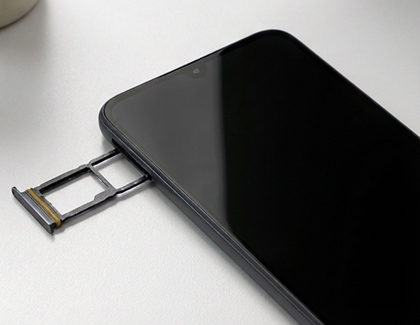 A Galaxy A17 with its long SIM and microSD card tray partially ejected from the side of the device.