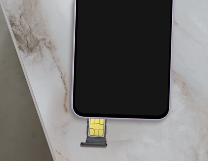 A purple Galaxy A37 shown from above with a SIM card tray containing a gold SIM card being inserted